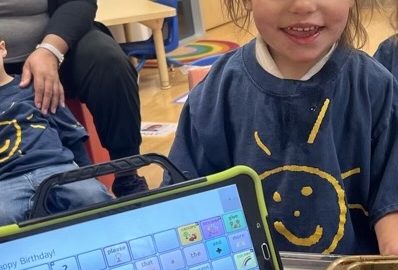 Young children's therapy client utilizing iPad to communicate