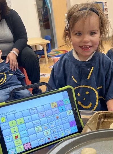 Young children's therapy client utilizing iPad to communicate