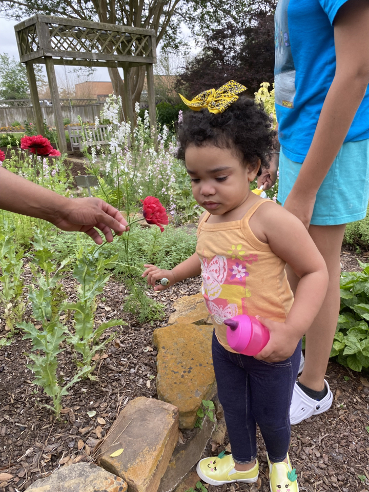 Isabella enjoying flowers during her SST session