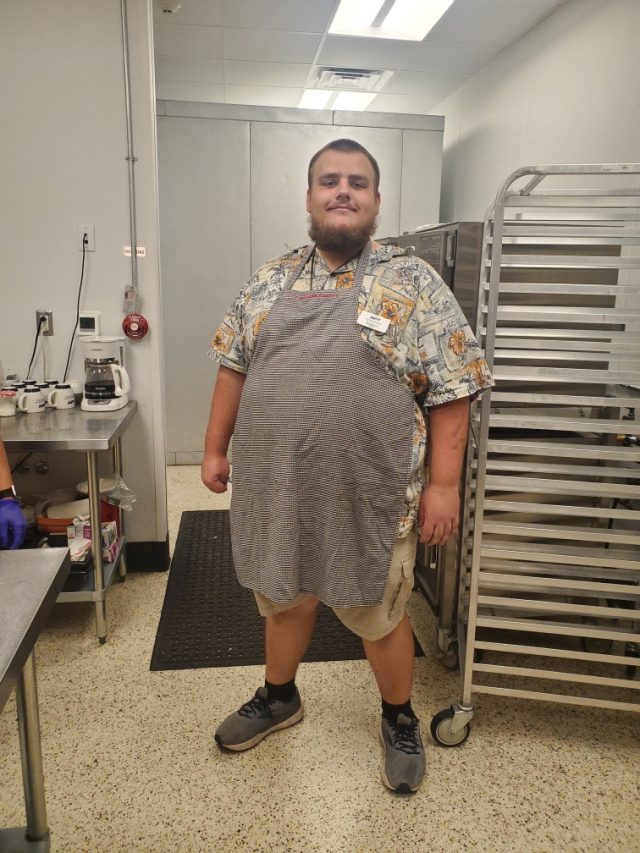 Former HSHT/RAMP student in apron