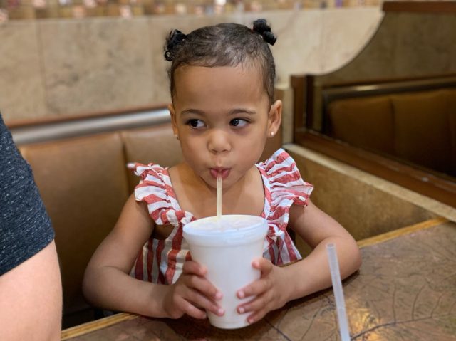 Little Girl drinking out of straw