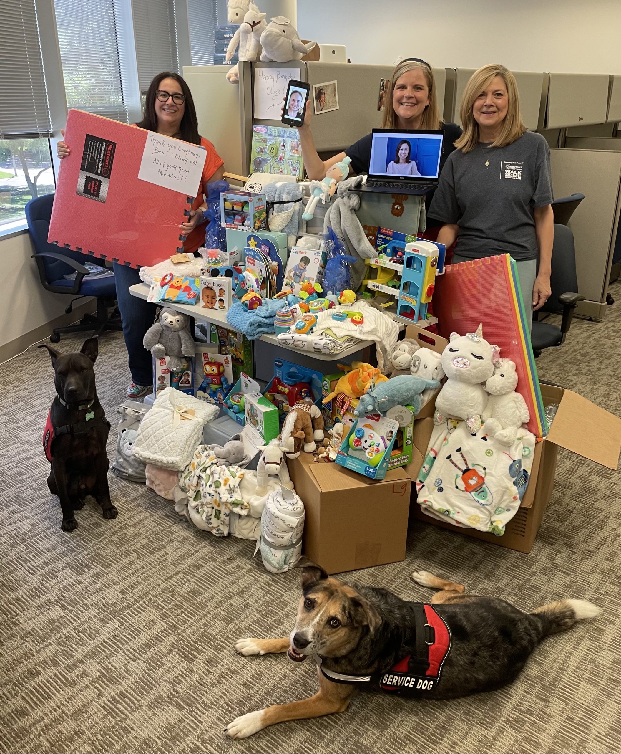 Therapists and service dogs with Holiday Adoption gifts