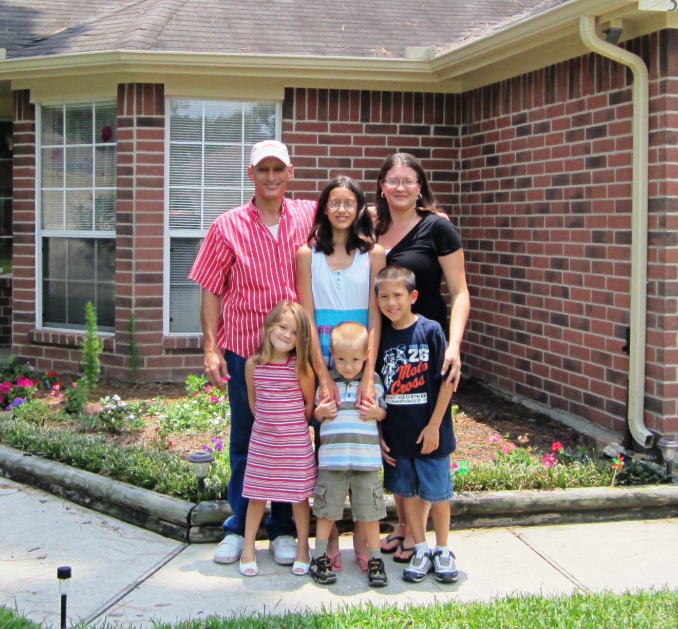 The Bailey family standing in front of their new home.