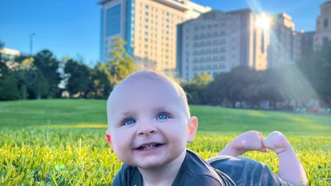 Baby Dax laying in the grass.