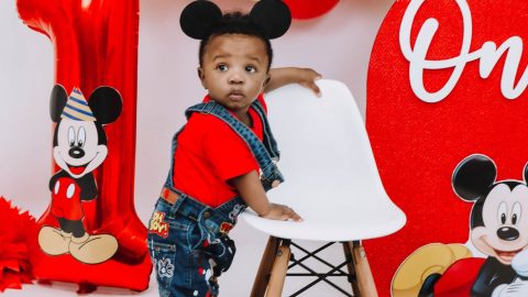 RJ in front of a Mickey Mouse themed balloon arch.